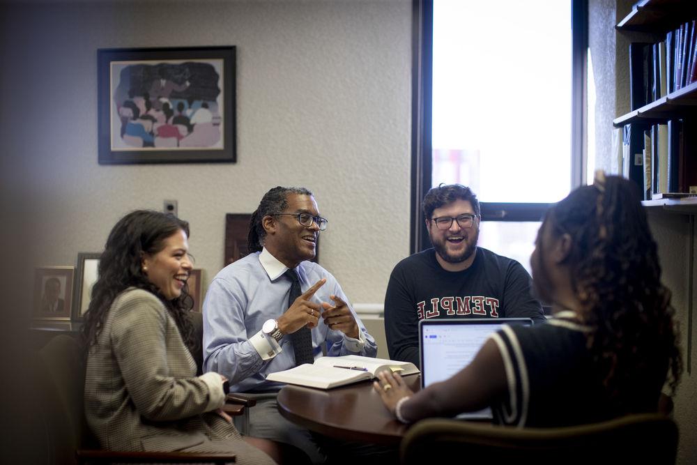 Law students and their professor discuss class topics.